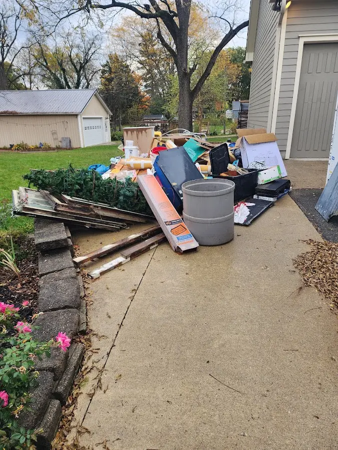 Dumpster being loaded with debris for Estate Cleanout Dumpster Rental in St. Francis